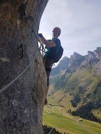 Crossing teep traverse on the via ferrata above Col d'Aravis